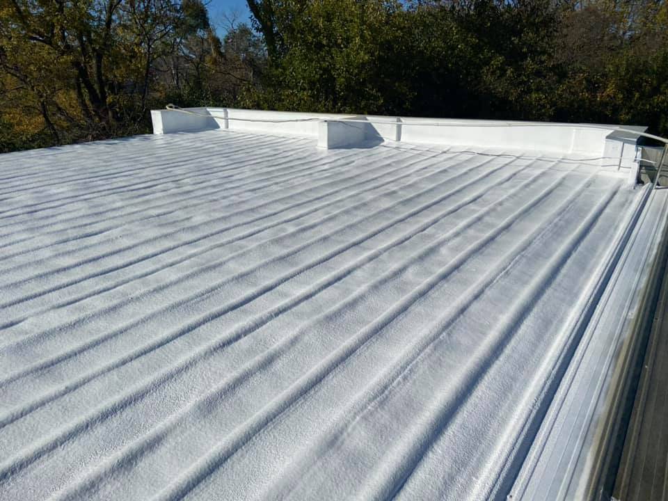 Conklin roof coatings applied on a metal roof in Des Moines, offering superior protection and durability.