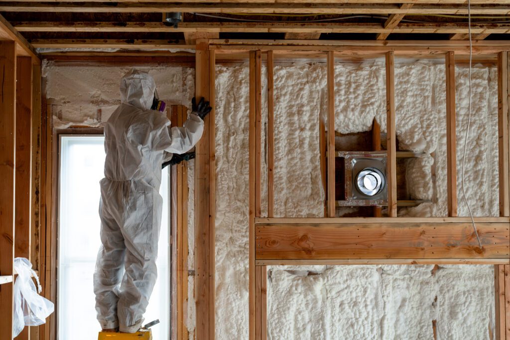 man working on house insulation